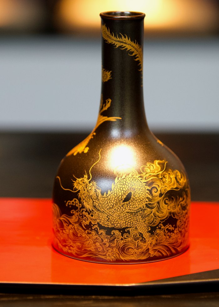 Jingdezhen porcelain — gold-painted dragon vase on lacquer base